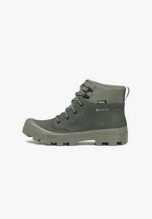 Botte montante kaki à lacets avec semelle texturée, étiquette Gore-Tex et col rembourré pour une utilisation en extérieur.