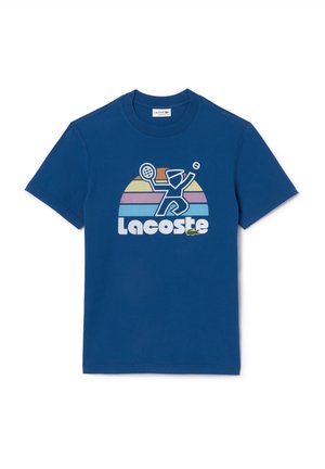 Blue short-sleeve t-shirt with a retro-style graphic of a tennis player, multicolored stripes, and the word Lacoste on the front.