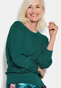 Tropfgrüner Strickpullover mit lockerer Passform, gerippten Ärmelabschlüssen und Saum. Verfügt über ein strukturiertes Muster und einen weiten Ausschnitt.