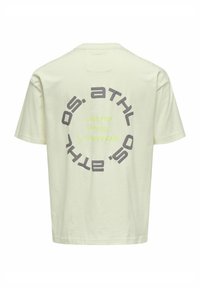 Hellgelbes Baumwoll-T-Shirt mit einem runden grafischen Design, das auf der Rückseite dunkelgrauen und neongrünen Text zeigt. Kurze Ärmel, Rundhalsausschnitt.