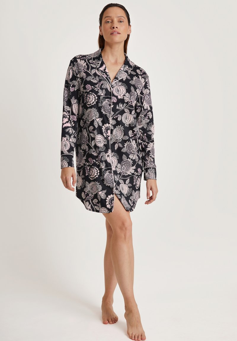 Schwarzes Nachthemd mit langen Ärmeln und floralen Mustern in Pink und Weiß, mit einer Knopfleiste vorne und einem abgerundeten Saum. Weicher Stoff.