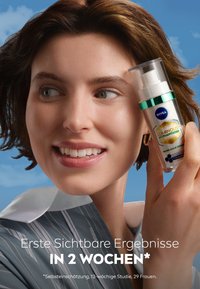 NIVEA Luminous Serum in a clear bottle with a silver pump and green accent. Model with short brown hair wears a gray striped shirt.