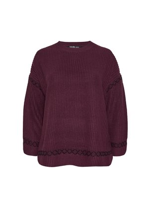 Tummanpunainen neulepaita leveillä hihoilla, jossa on mustat geometriset kuvioinnit helman ja hihansuiden kohdalla. Pyöreä kaula-aukko ja rento malli.