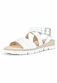 Sandale blanche à lanières avec une boucle, dotée d'une semelle intérieure douce et d'une semelle en caoutchouc texturée. Matériau en cuir lisse et design minimaliste.