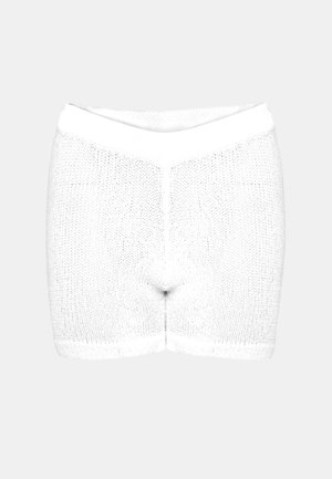 Vita stickade shorts med en tät väv, elastisk midja och en sömlös design vid benöppningarna. Minimalistisk och funktionell stil.