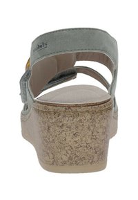 Sandalo grigio in suede con tacco in sughero, cinturino posteriore regolabile, soletta imbottita e design minimalista caratterizzato da una forma arrotondata.