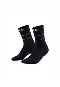 Calcetines deportivos negros con textura acanalada, que presentan rayas horizontales grises y un logo, diseñados para comodidad y rendimiento.
