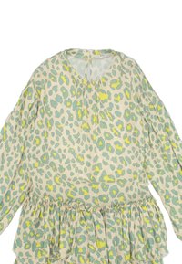 Leopardenmuster Bluse mit langen Ärmeln, rundem Halsausschnitt, gerafftem Taillenbund, mit pastellgrünen und gelben Punkten auf einem cremefarbenen Hintergrund.