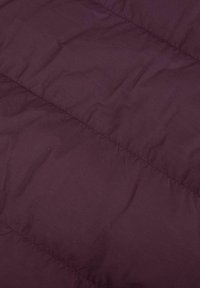 Tessuto trapuntato di colore viola scuro con una texture liscia, caratterizzato da cuciture orizzontali e pieghe visibili. Design con isolamento leggero.