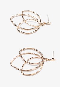 Gold-tone metal earrings featuring a layered, open design with three interconnected oval shapes. Smooth texture, shiny finish, and stud post closure.
