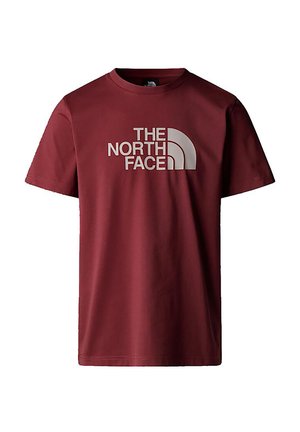Bordeauxfarbendes Baumwoll-T-Shirt mit kurzen Ärmeln, das auf der Vorderseite einen auffälligen weißen Schriftzug "THE NORTH FACE" sowie ein mondförmiges Designmotiv zeigt.
