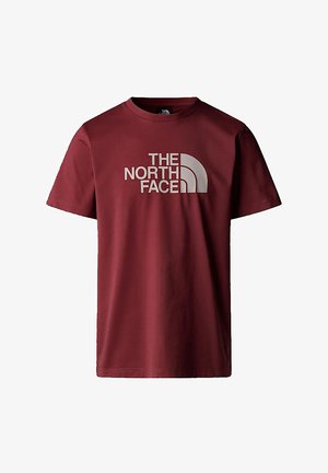 Maroon cotton t-shirt with short sleeves, featuring a bold white logo text "THE NORTH FACE" and a crescent design motif on the front.
