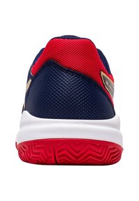 Męskie buty sportowe z granatową cholewką, czerwonymi akcentami z siatki i białą podeszwą środkową. Posiadają teksturowaną podeszwę z czerwonymi wzorami trakcjonymi.