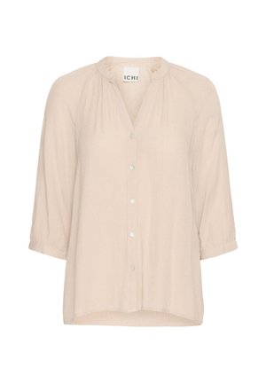 Lys beige bluse med V-hals og knaplukning foran. Har trekvartlange ærmer, sammensydde detaljer og en lett løs passform. Mykt, teksturert stoff.