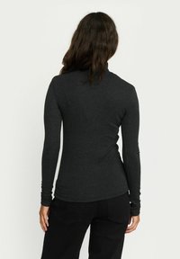 Black long-sleeve top in a fitted design, made of soft, stretchy fabric with a round neckline and subtle seams along the back.