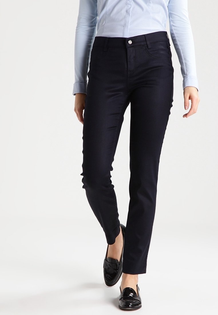 Dark blue, slim-fit trousers with a smooth texture, five pockets, and a button closure. Worn with a light blue shirt and black loafers.