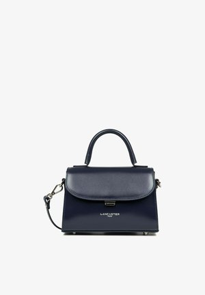 Navy blue leather handbag with a structured design, top handle, detachable strap, and metallic brand detail at the front.