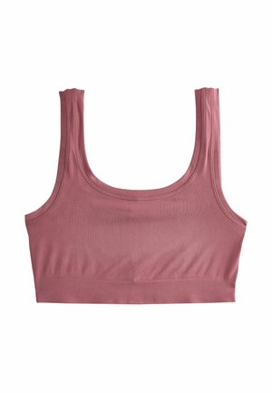 Dammig rosa crop top med breda band, slät textur och en tajt design. Har en sömlös finish och ett elastiskt band i botten.