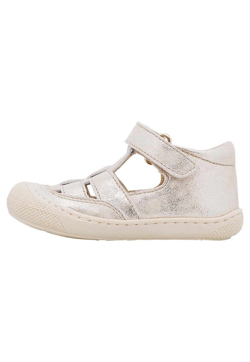 Sandales à bout fermé en argent métallisé avec découpes, bride réglable et semelle en caoutchouc texturée. Design plat avec des détails de couture le long des bords.