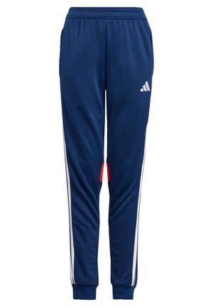 Pantalons de jogging bleu marine avec des rayures blanches sur le côté, taille élastique et accent rouge près de l'ourlet. Fabriqués en matériau lisse et léger.