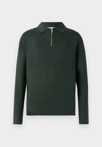 Mørkegrønn langermet polo-skjorte med krage og halv-lomme foran. Laget av et mykt materiale med en jevn tekstur.