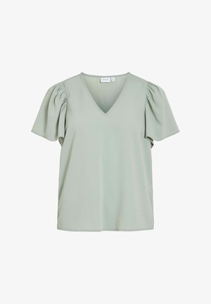 Hele roheline lühikeste varrukatega särk, mis on valmistatud pehmest kangast, V-kaelusega ja puhvargustega. Särgil on sile tekstuur ja minimaalne kaunistus.