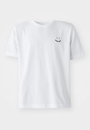 White short-sleeve t-shirt made of cotton, featuring a small black smiley graphic and text on the front left chest area.