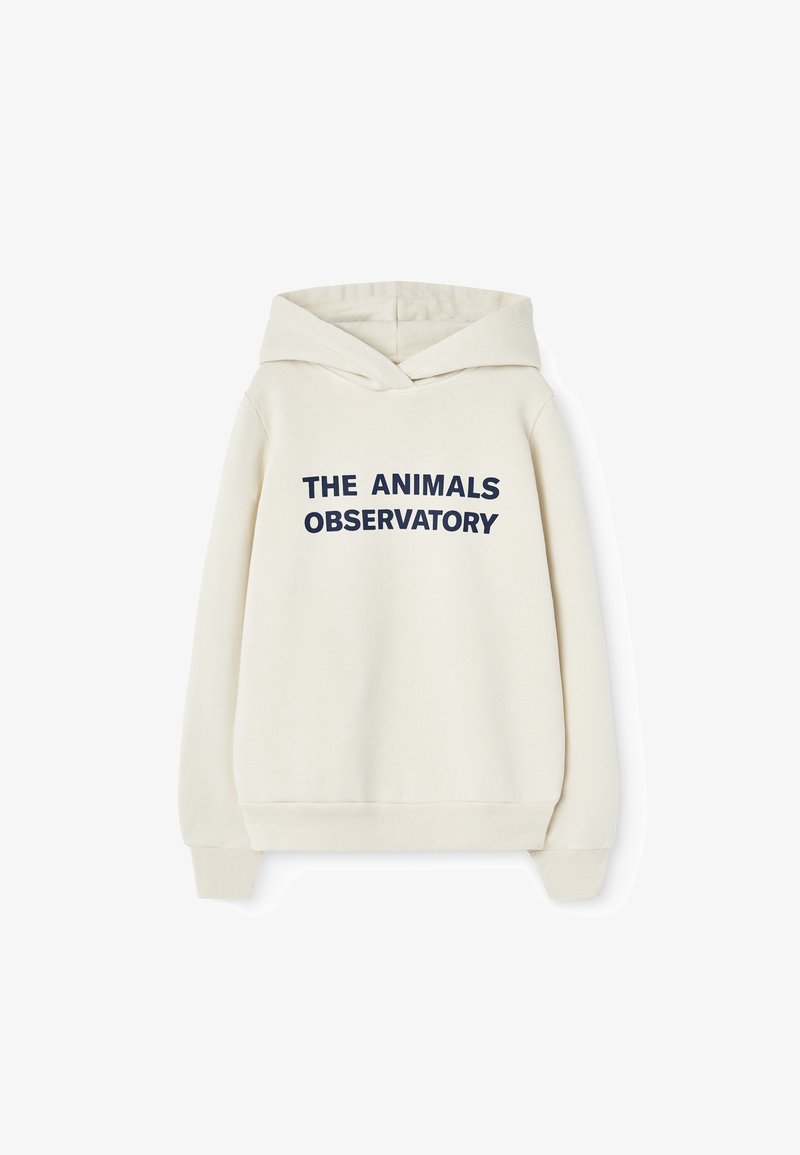 Kremfarget hettegenser med stor marineblå tekst som sier "THE ANIMALS OBSERVATORY," med snor i hetten og ribbestrikkede ermer.