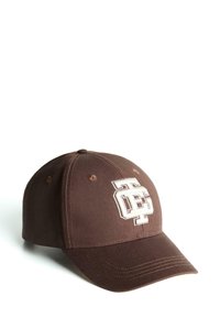 Brown baseball cap made of fabric, featuring white embroidered logo on the front. Curved brim with stitched detailing. Classic 5-panel design.