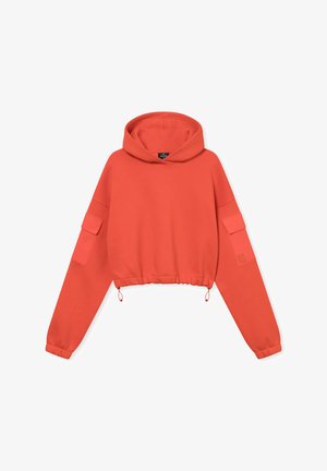 Korall színű, rövidített kapucnis pulóver, húzózsinórral az alján, hosszú ujjal és két oldalsó zsebbel. Puha anyagból készült, pulóver stílusú és kapucnis.