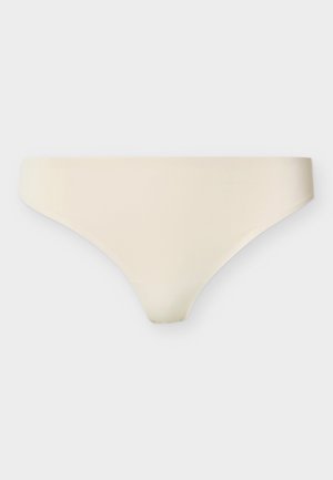 Sous-vêtements bikini beige sans couture, en tissu lisse sans coutures ni motifs visibles, présentés sur un fond clair uni.