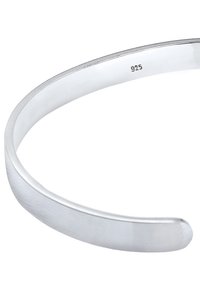 Silver bracelet in 925 sterling silver, with a smooth, rounded shape and polished finish. Features a subtle texture and a tapered end.