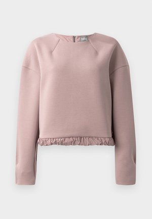 Lys rosa sweatshirt laget av mykt materiale, med rund hals, lange ermer og volangkant. Glidelåsdetalj bak.