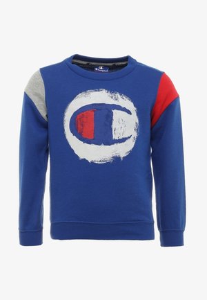 Blå sweatshirt med långa ärmar, med en stor cirkulär logotyp i vitt, blått och rött. Grå axelaccenter. Mjukt, texturerat tyg.