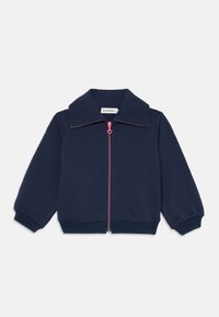 Giacca con zip blu navy, caratterizzata da un ampio colletto, zip rosa, polsini e orlo a coste. Tessuto morbido con una trama solida e liscia.