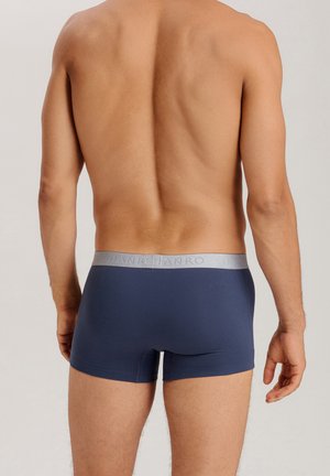 Men's navy blue boxer briefs made of soft fabric, featuring a gray elastic waistband with brand logo, close-fitting design, and smooth texture.