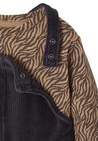 Brown and beige striped long-sleeve top paired with a thick, dark purple corduroy overall featuring snap-button accents.