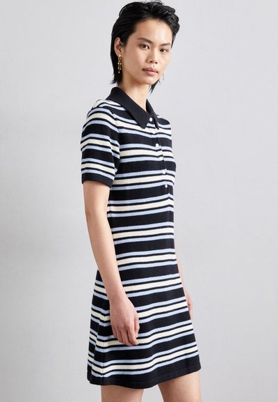 Striped polo dress featuring navy and white colors, short sleeves, button closure, and a collar. Made from textured knit material.