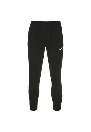 Schwarze Sporthose mit elastischem Bund, schmal zulaufendem Bein und kleinem weißen Nike-Logo auf dem Oberschenkel. Mit minimalem grünen Akzent.
