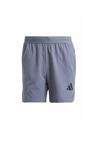 Pantaloni sportivi grigi con vita elasticizzata, tessuto strutturato, tasche laterali e un logo nero sulla parte bassa della gamba sinistra.