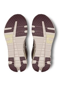 Shoe outsole in brown and beige with textured grip pattern; features prominent grooves and a light rubber material for traction.