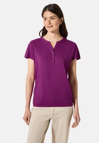 Top viola a maniche corte con scollatura henley e tre bottoni. Realizzato in tessuto morbido, presenta una vestibilità rilassata e una texture liscia.