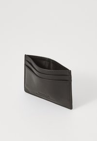 Black leather cardholder with four card slots and a subtle embossed logo on the front, featuring a smooth texture and minimalist design.