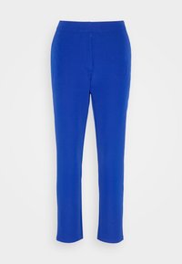 Pantalon slim bleu à taille mi-haute et devant plat, présenté sur un fond blanc.