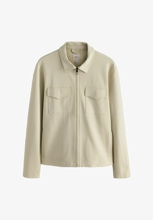 Veste zippée beige clair avec col, deux poches poitrine et poches latérales. Fabriquée en tissu texturé avec une coupe décontractée.