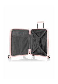 Maleta dura rosa con un interior negro, que cuenta con un bolsillo de malla, cintas elásticas, ruedas dobles y un asa retráctil.