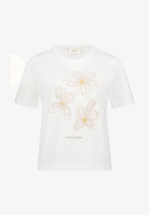 Bílé tričko s krátkými rukávy, na němž jsou tři vyšívané béžové květiny a pod nimi uprostřed nápis "FLOWER GARDEN".