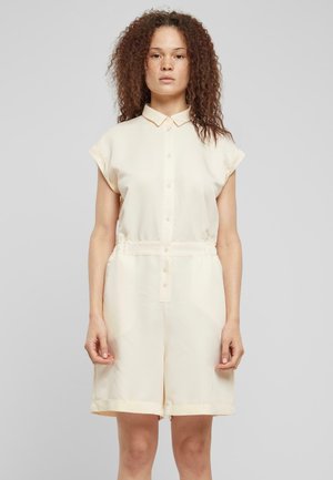 Crème kraagloze jurk met korte mouwen, gemaakt van een gladde stof. Voorzien van een knoopsluiting aan de voorkant en een elastische taille voor een mooie pasvorm.