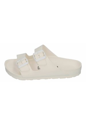 White slip-on sandals made of durable material, featuring two adjustable buckles, a flat sole, and a minimalist design.