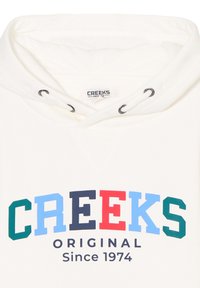 Felpa bianca con cappuccio, caratterizzata da una stampa grafica multicolore "CREEKS ORIGINAL" e "Dal 1974" in blu scuro sul davanti.